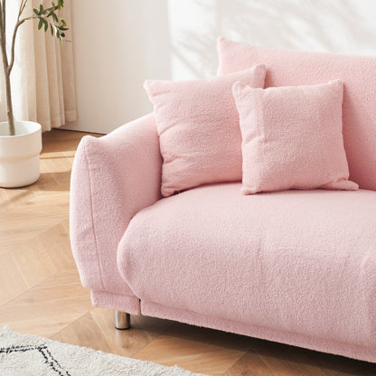 Divano rosa in pile di peluche da 86,6 pollici con quattro cuscini e piedini in metallo che può stare comodamente in una camera da letto di un appartamento