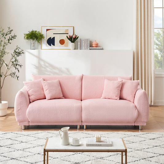 Divano rosa in pile di peluche da 86,6 pollici con quattro cuscini e piedini in metallo che può stare comodamente in una camera da letto di un appartamento