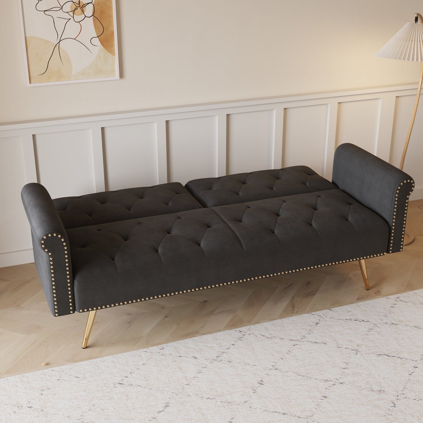 Un divano letto lungo 69,7 pollici rivestito in tessuto di velluto, con finiture a borchie e accompagnato da un cuscino coordinato.