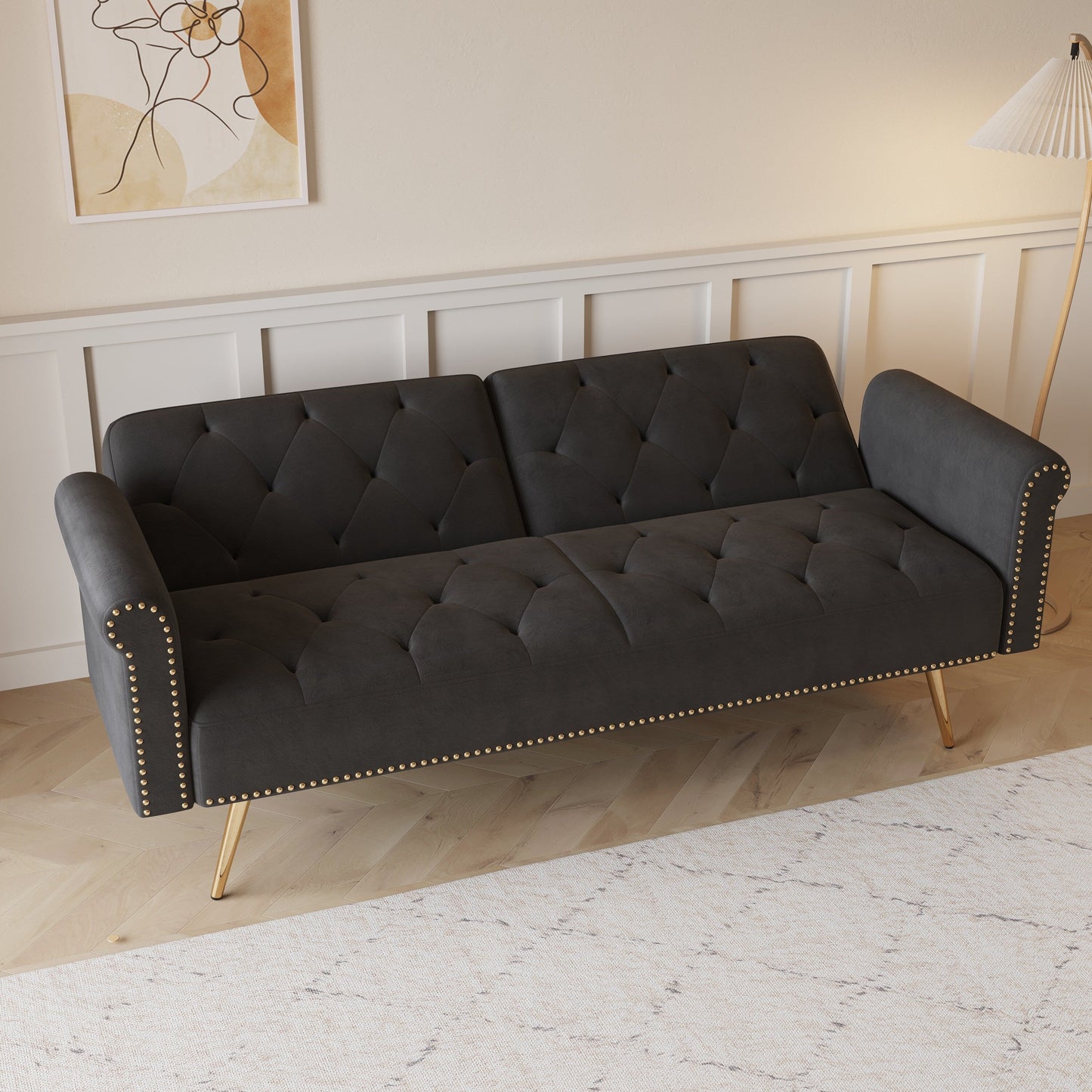 Un divano letto lungo 69,7 pollici rivestito in tessuto di velluto, con finiture a borchie e accompagnato da un cuscino coordinato.