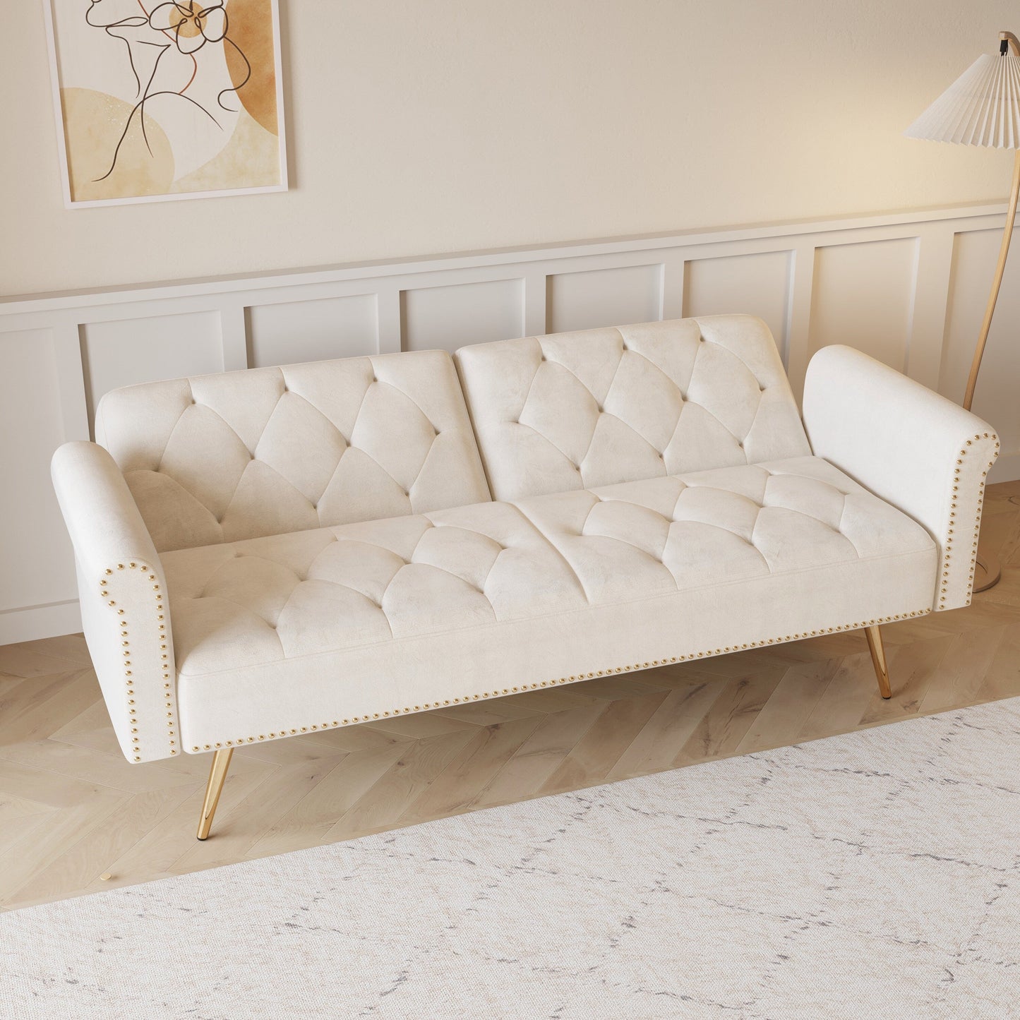 Un divano letto lungo 69,7 pollici rivestito in tessuto di velluto, con finiture a borchie e accompagnato da un cuscino coordinato.