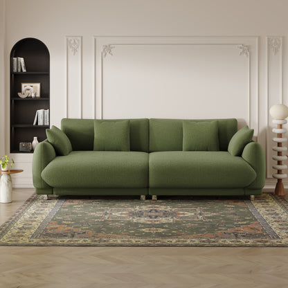 Un divano verde in lana teddy da 86,6 pollici con quattro cuscini e piedini in metallo che può stare comodamente in una camera da letto di un appartamento con