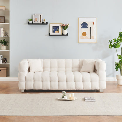 Divano Teddy beige a 3 posti con due cuscini decorativi